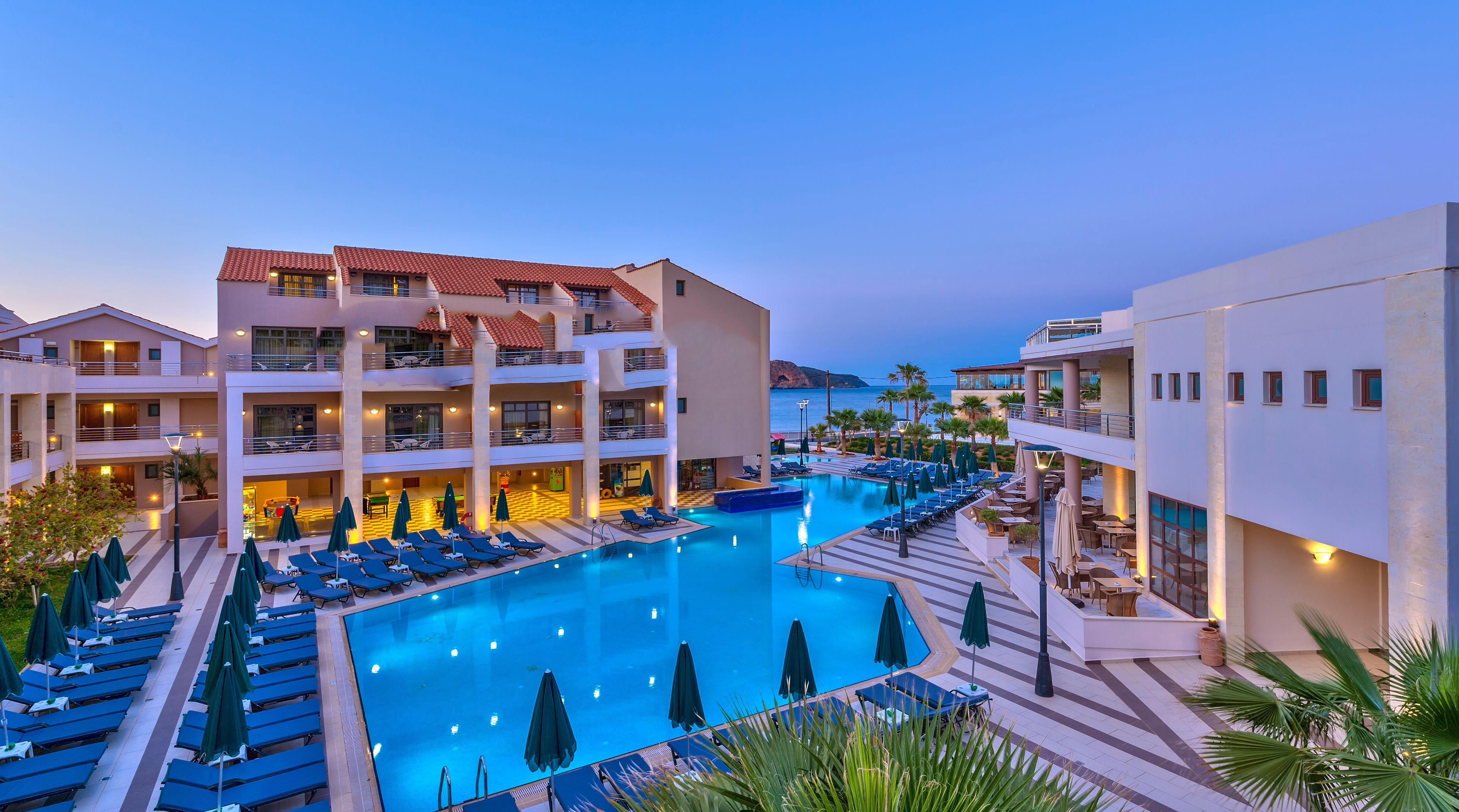 Porto Platanias Beach Resort & Spa Exterior photo The resort at night