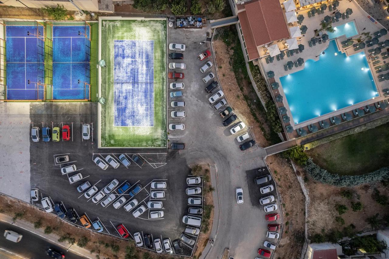 Porto Platanias Beach Resort & Spa Exterior photo Aerial view of the tennis courts
