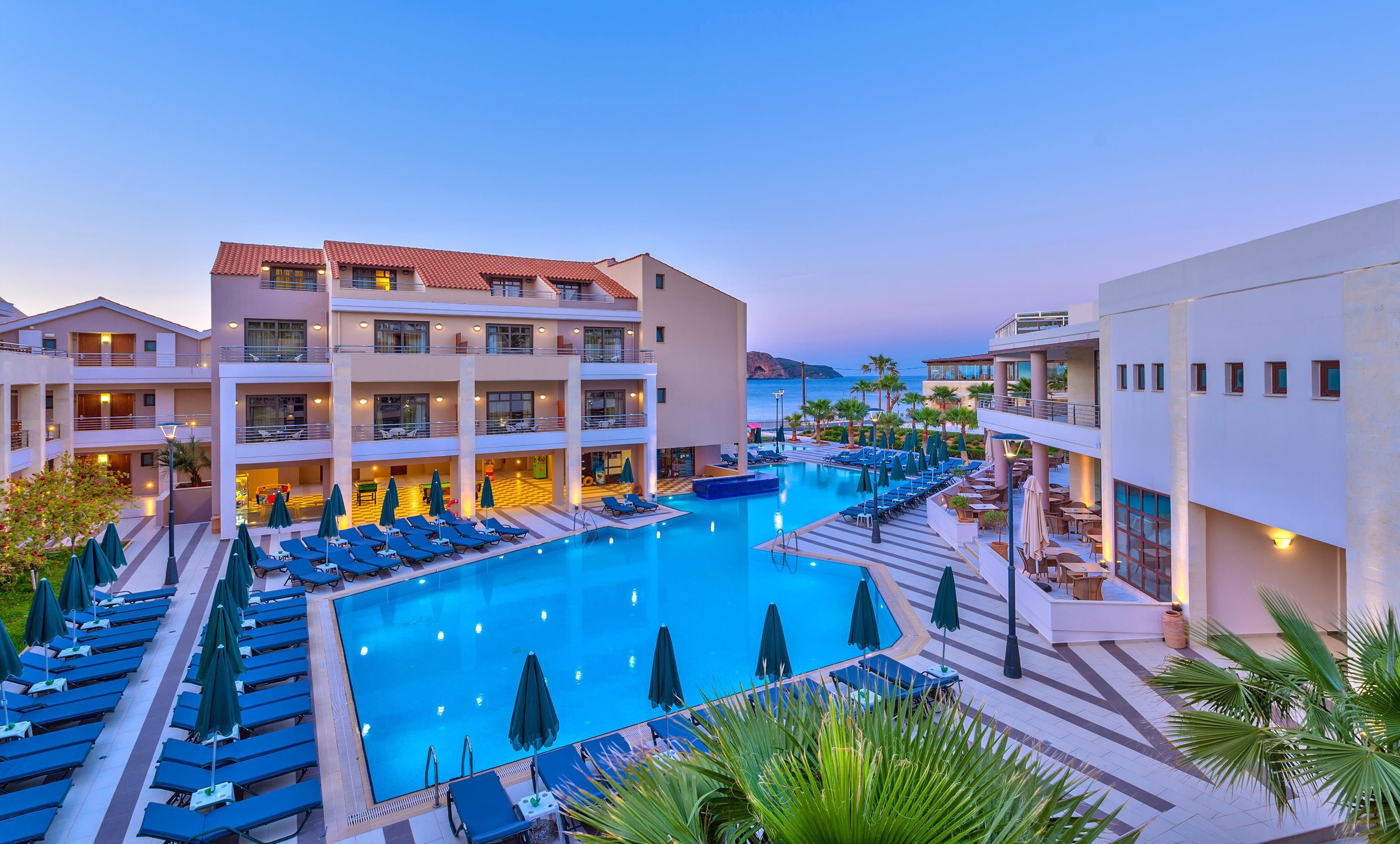 Porto Platanias Beach Resort & Spa Exterior photo The resort at night